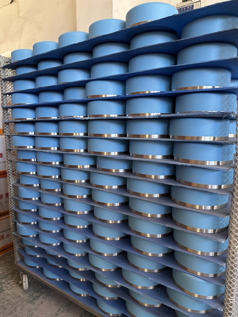 Blue coated food container components prepared for assembly